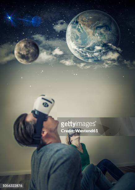 young couple using virtual reality glasses at home, composite - world war 2 stock-fotos und bilder