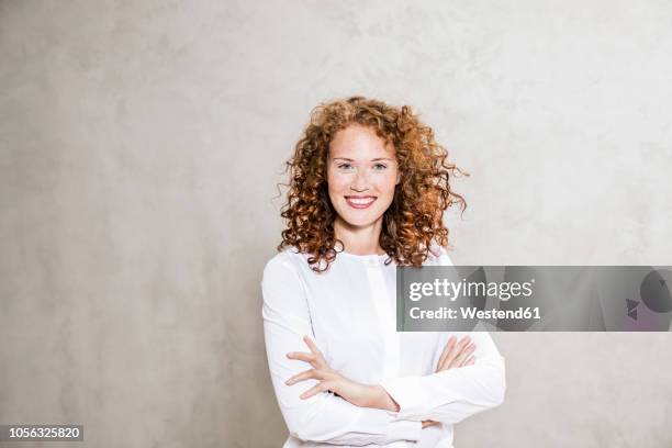 portrait of laughing redheaded young woman with arms crossed - admiration stock pictures, royalty-free photos & images