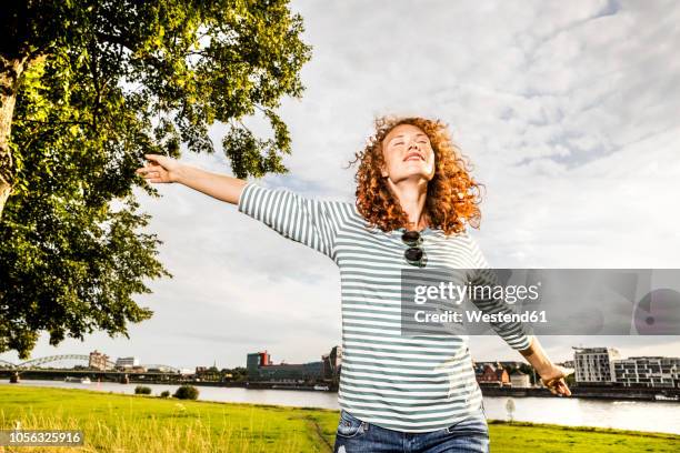 germany, cologne, young woman enjoying sunlight - striped shirt stock pictures, royalty-free photos & images