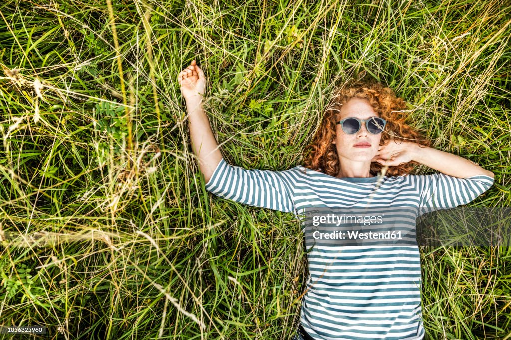 Portrait of young woman relaxing on a meadow
