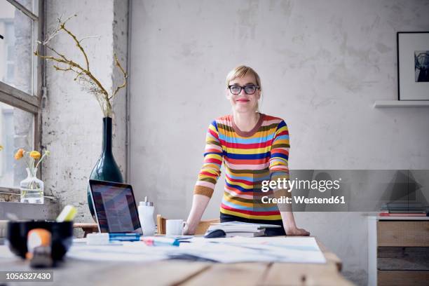 portrait of smiling woman at desk in a loft - person standing front on inside bildbanksfoton och bilder