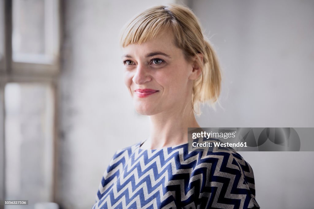 Portrait of happy blond businesswoman