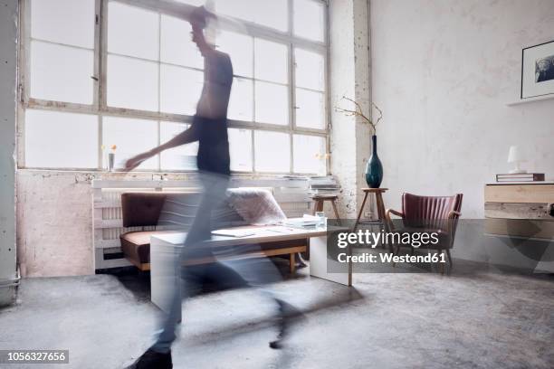 woman walking in a loft - shabby chic stockfoto's en -beelden