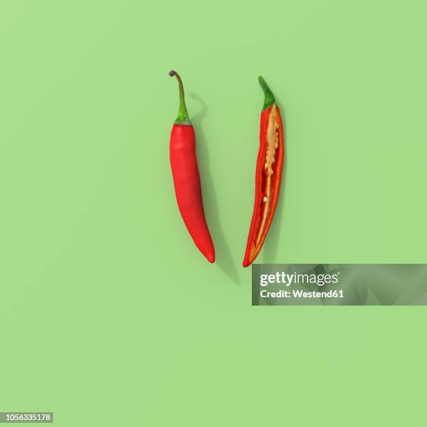 stockillustraties, clipart, cartoons en iconen met 3d rendering, sliced red chili on green background - pepper