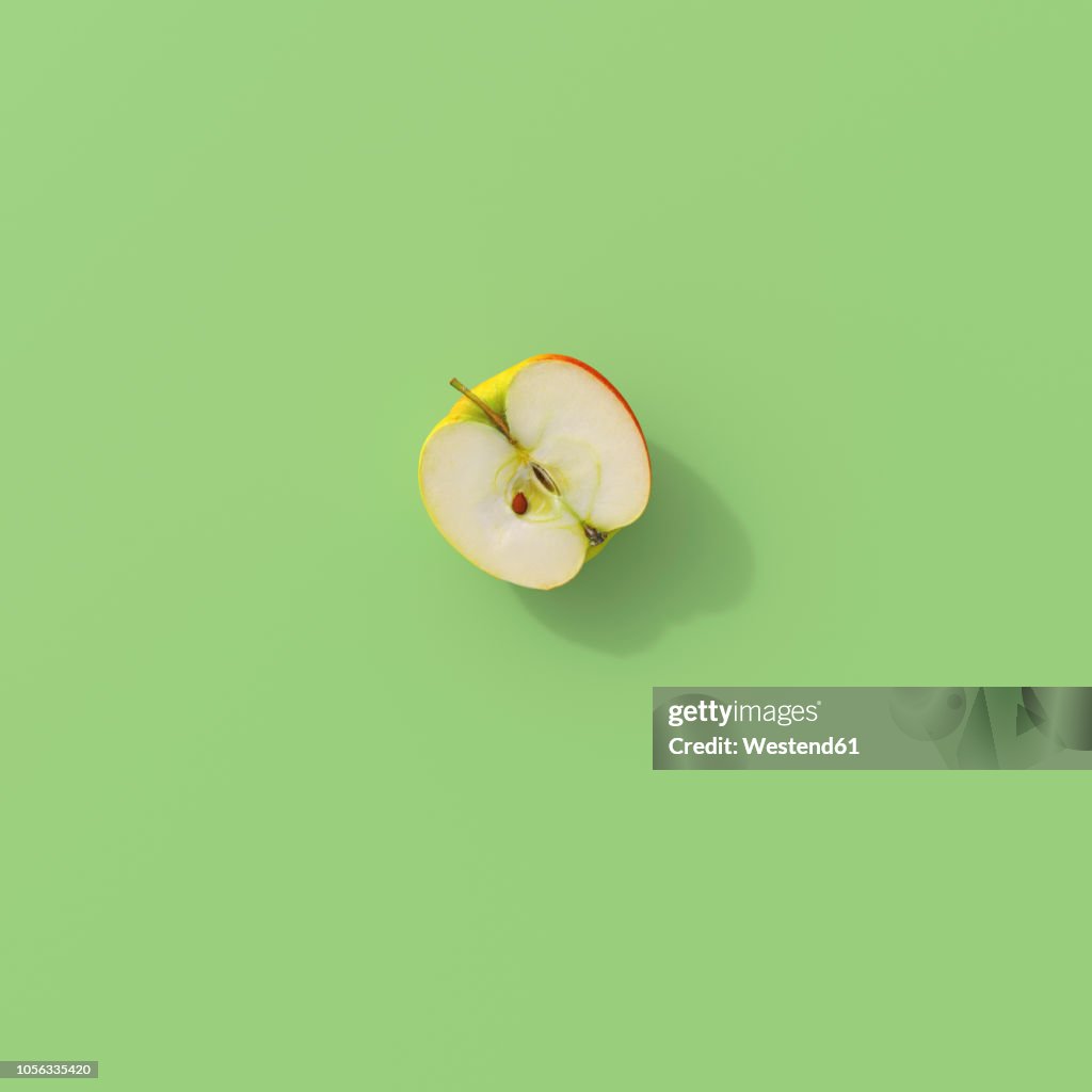 3D rendering, Halved apple on green background