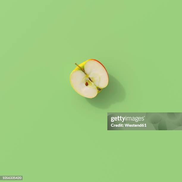 ilustrações de stock, clip art, desenhos animados e ícones de 3d rendering, halved apple on green background - maçã