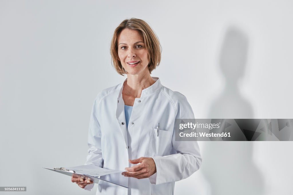 Portrait of female doctor with anamnesis questionnaire