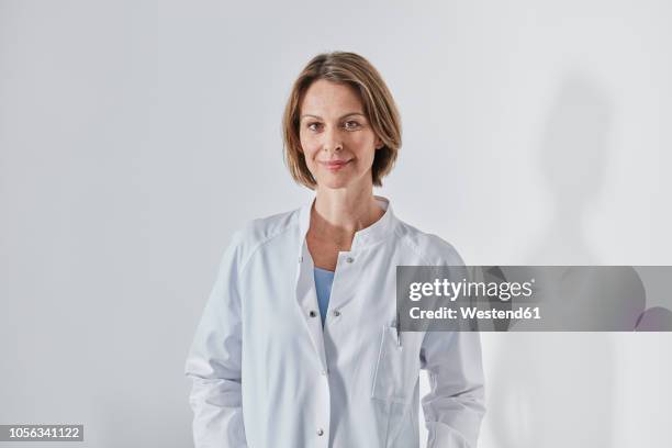 portrait of female doctor - confident man white background stock-fotos und bilder