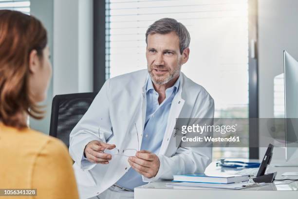 physician patient talk - doctor desk stock pictures, royalty-free photos & images