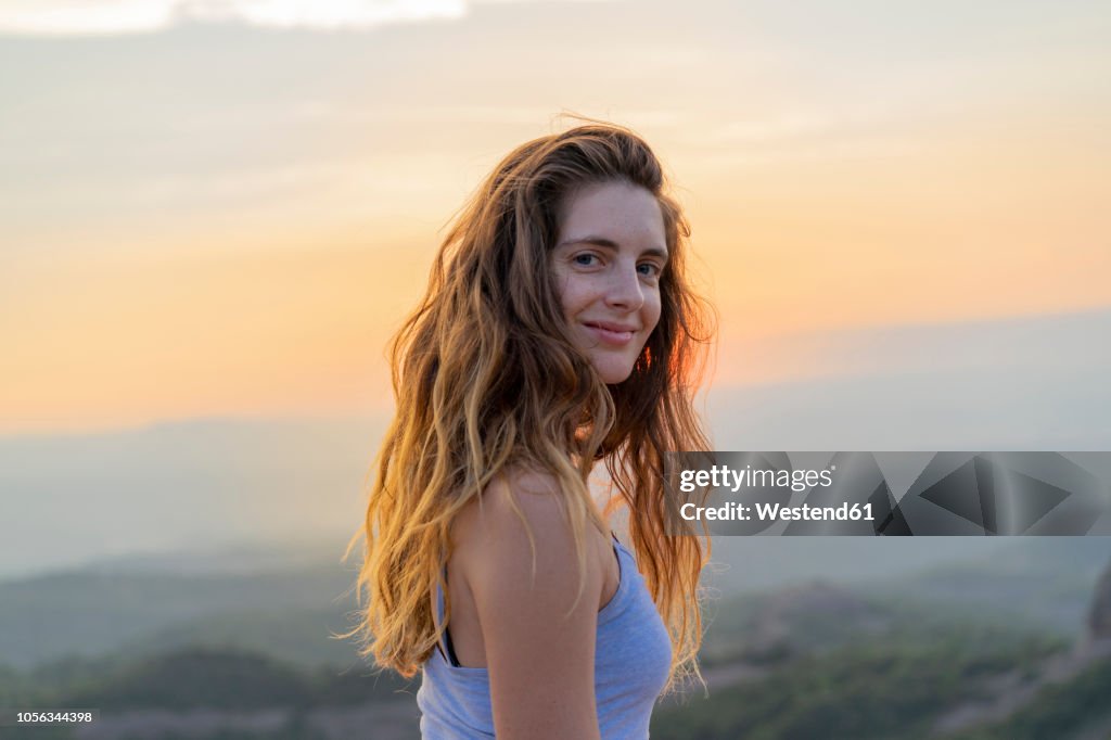 Woman watching sunset in the mountains