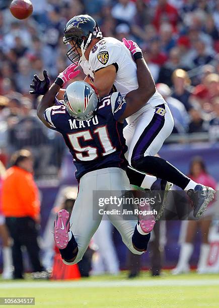 Jerod Mayo of the New England Patriots collides with Todd Heap of the Baltimore Ravens at Gillette Stadium on October 17, 2010 in Foxboro,...