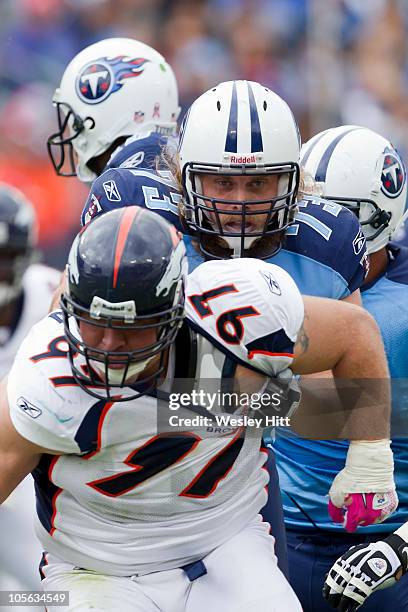 Jake Scott of the Tennessee Titans blocks Justin Bannan of the Denver Broncos at LP Field on October 3, 2010 in Nashville, Tennessee. The Broncos...