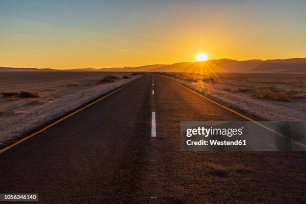 africa, namibia, namib desert, naukluft national park, empty road at sunset - road horizon stock pictures, royalty-free photos & images