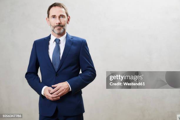 portrait of businessman - blue suit stock-fotos und bilder