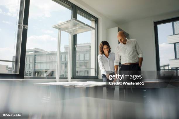 two architects working in office, discussing blueprints - 2018 blueprint stock pictures, royalty-free photos & images