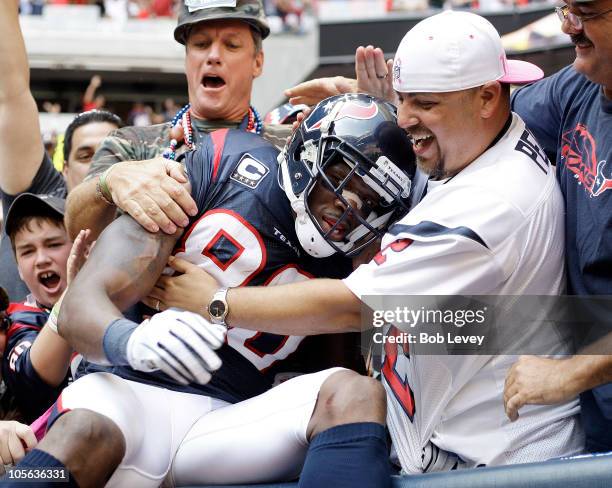 Andre Johnson of the Houston Texans is mobbed by fans after he scored the go ahead touchdown in the fourth quarter against the Kansas City Chiefs at...