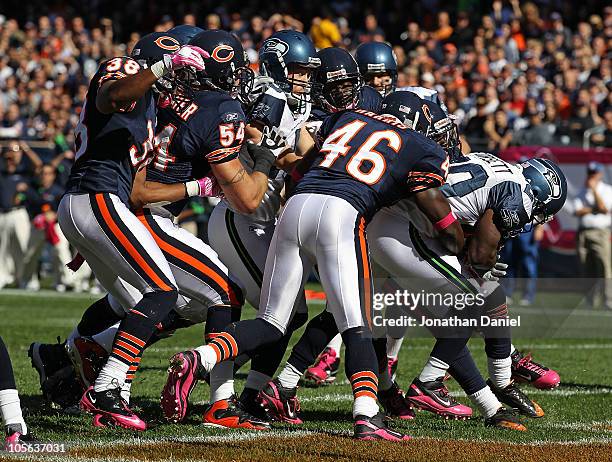 Justin Forsett of the Seattle Seahawks scores a touchdown pursues by Chris Harris, Brian Urlacher and Danieal Manning of the Chicago Bears at Soldier...