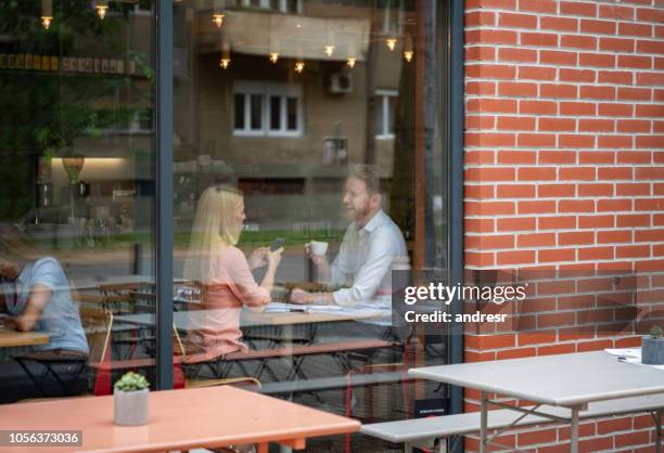 happy couple on a date at a cafe - coffee shop couple stock pictures, royalty-free photos & images