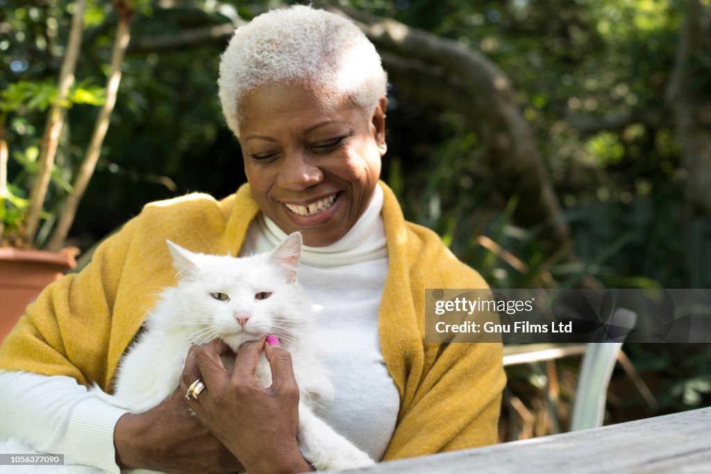 Senior Woman Cuddling Cat