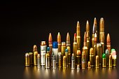 Different types of ammunition on a black background. Sale of weapons and ammunition. The right to hold a gun.