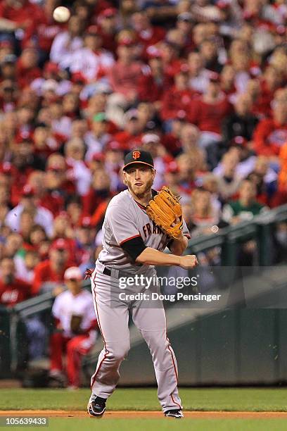 Mike Fontenot of the San Francisco Giants throws an errant throw to first base on a ball hit by Placido Polanco of the Philadelphia Phillies leading...