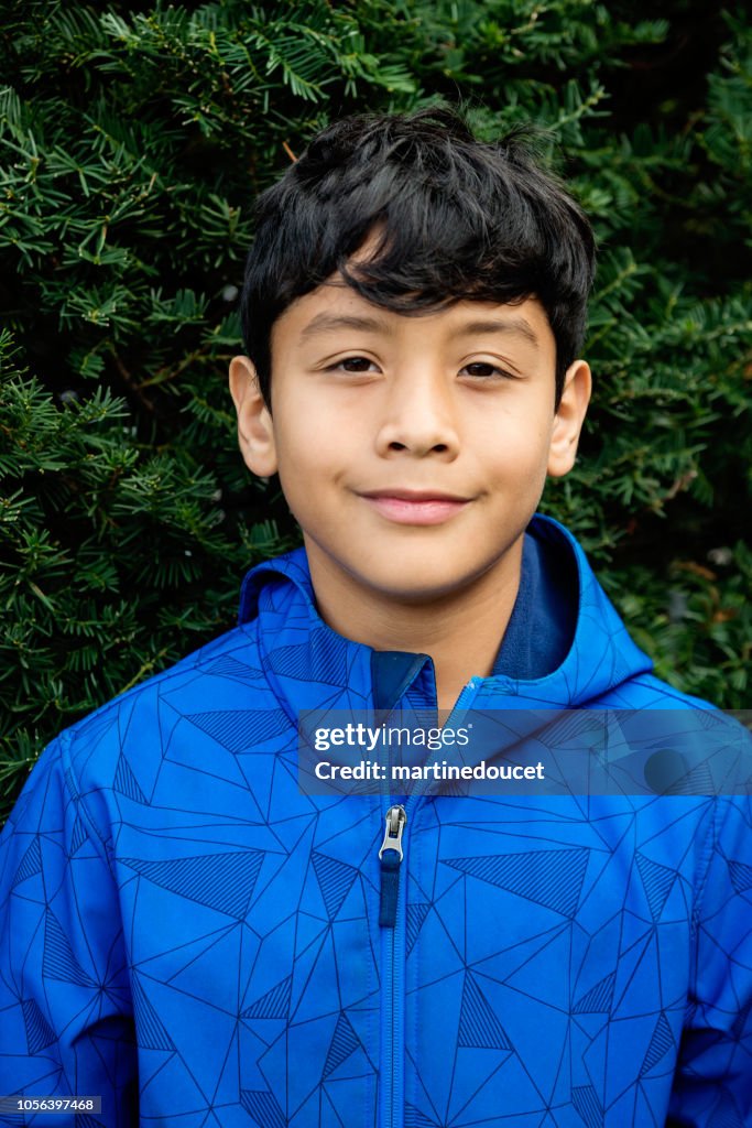 Latin American preteen boy portrait outdoors.