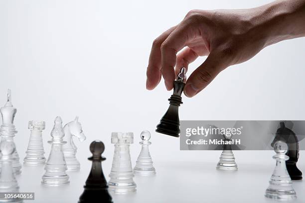 the manual up which picks up black king - chess strategy stock pictures, royalty-free photos & images