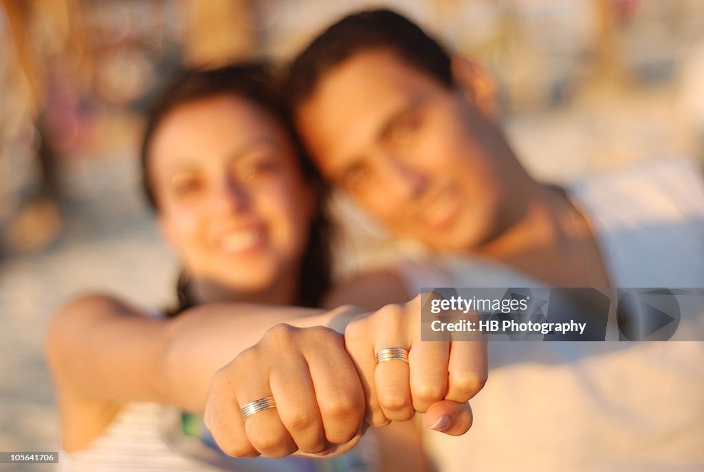 Engaged Couple showing their rings