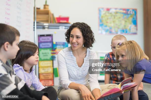 story time in an elementary classroom - montessori education stock pictures, royalty-free photos & images