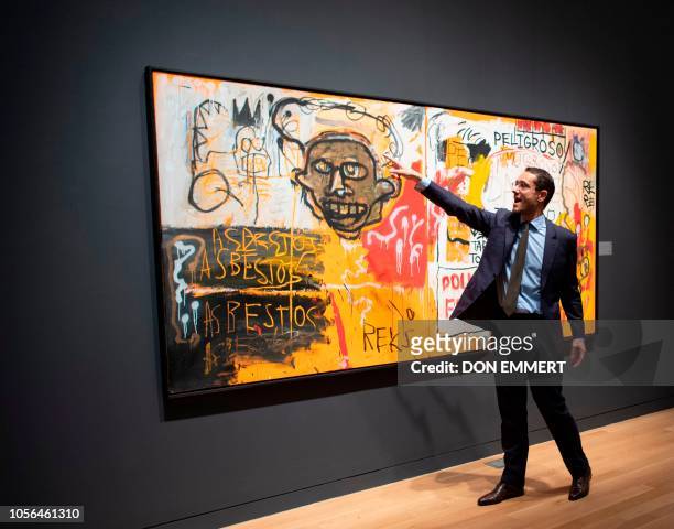 Sotheby's employee talks about Jean-Michel Basquiat's "untitled ," on November 2 at Sotheby's Auction house in New York. - The piece is part of the...