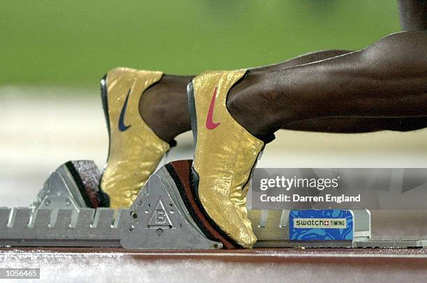 Michael Johnson of the USA prepares to leave the blocks in his Golden shoes in the Semi final of the Men's 400m at the Sydney 2000 Olympic Games held...