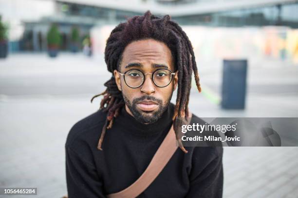 portrait of a young african american man - locs hairstyle stock pictures, royalty-free photos & images