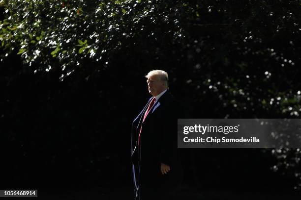 President Donald Trump walks across the South Lawn before boarding Marine One and departing the White House October 18, 2018 in Washington, DC. Trump...