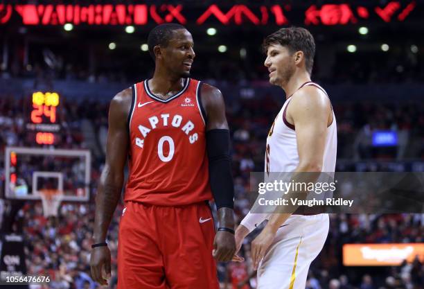 Miles of the Toronto Raptors talks with Kyle Korver of the Cleveland Cavaliers during the second half of the NBA season opener at Scotiabank Arena on...