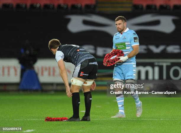 Glasgow Warriors' Adam Ashe and Ospreys' Olly Cracknell lay wreathes before kick-off during the Guinness Pro14 Round match between Ospreys and...