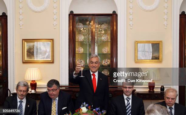 Chilean President Sebastian Pinera raises a toast during luncheon at Mansion House on October 18, 2010 in London, England. Mr Pinera who is currently...
