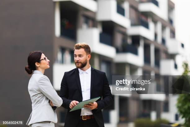 real estate agent with a client - real estate investing stock pictures, royalty-free photos & images