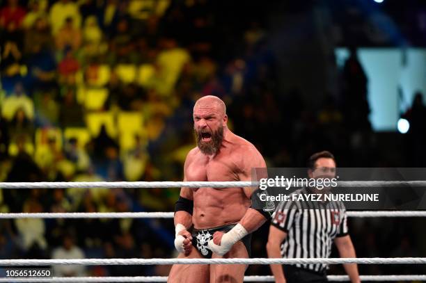 Triple H reacts during a tag team match as part of as part of the World Wrestling Entertainment Crown Jewel pay-per-view at the King Saud University...