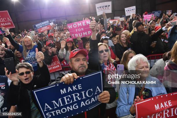 People cheer as US President Donald Trump arrives to speak at a campaign rally at the Huntington Tri-State Airport, on November 2 in Huntington, West...