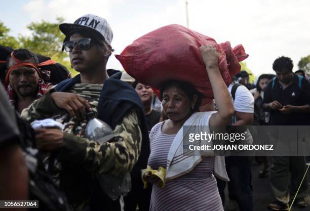 Group of Salvadorean migrant moving towards the United States in hopes of a better life or to escape violence, walk between Ciudad Hidalgo and...