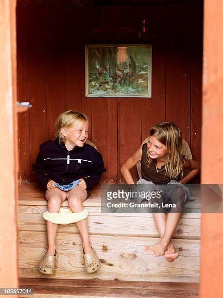 girls sitting in outhouse - outhouse stock pictures, royalty-free photos & images