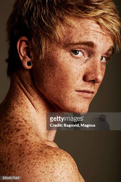 Shirtless freckled man, looking at camera