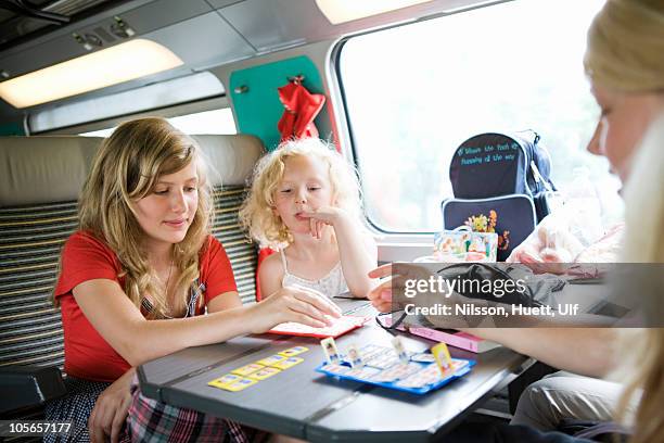 girls playing game in train - travelgame stock pictures, royalty-free photos & images