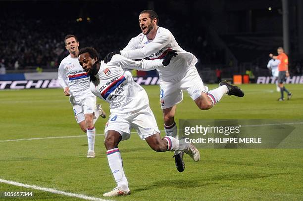 Lyon forward Sidney Govou is congratulated by teammate Argentinian forward Lisandro Lopez after scoring a goal during the French L1 football match...