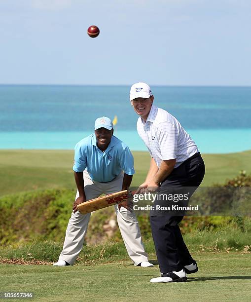Ernie Els of South Africa tries his had at cricket with former test star Brian Lara keeping wicket during the pro-am event prior to the PGA Grand...