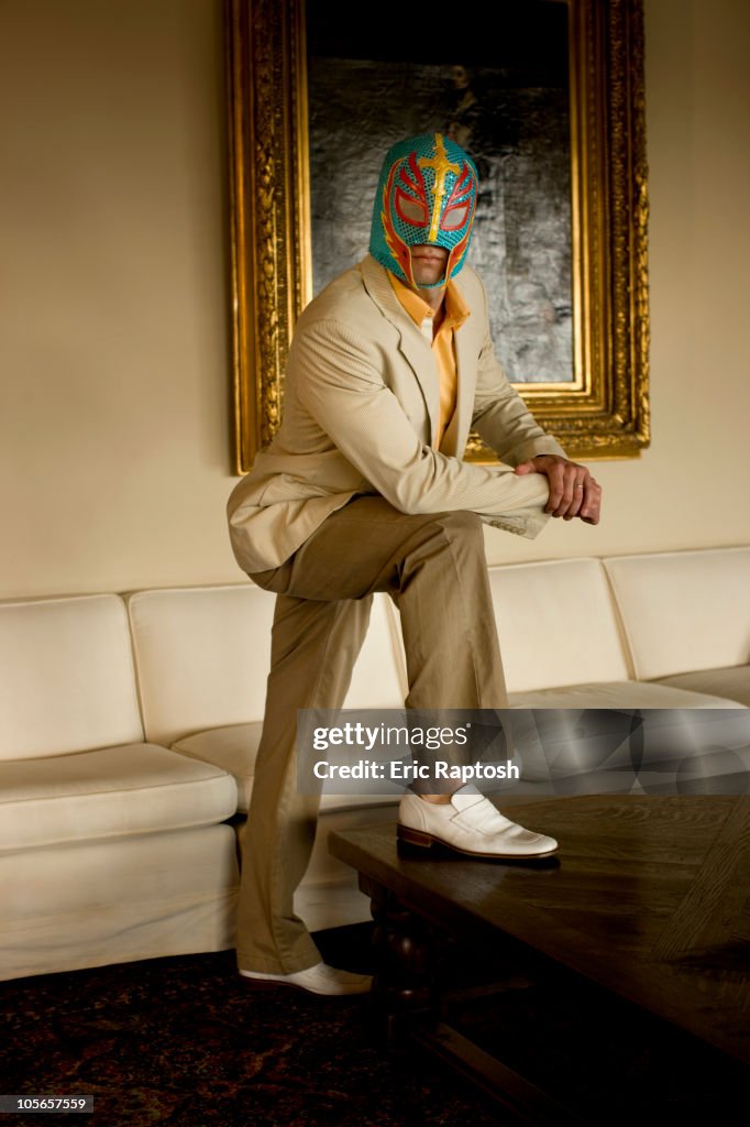 Man wearing wrestling mask in living room