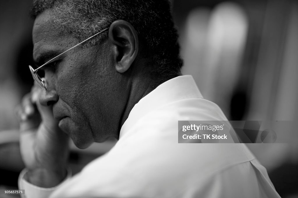 Mixed race businessman looking down