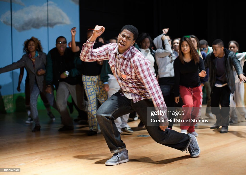 Teenagers rehearsing on stage