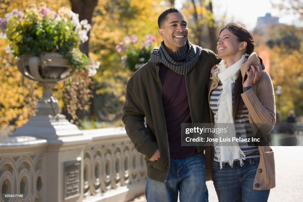 Smiling couple walking in park