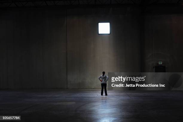 black woman standing in empty warehouse - women wearing nothing stock pictures, royalty-free photos & images